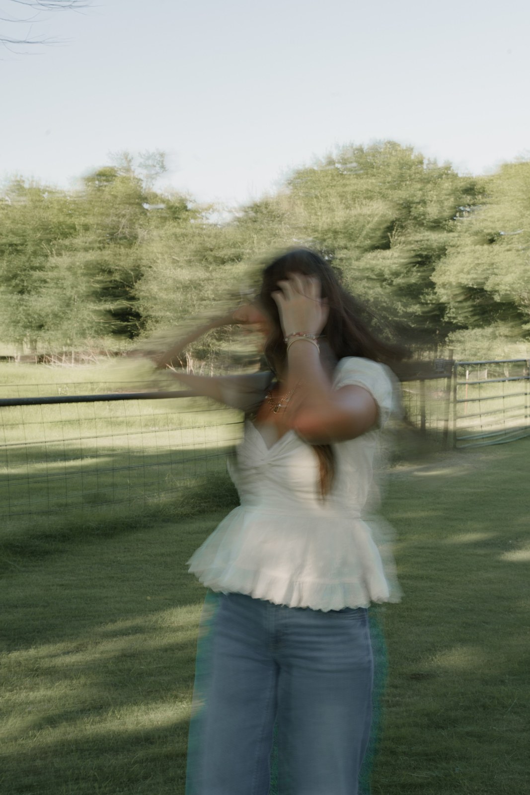 Woman twirling in motion blur in a park