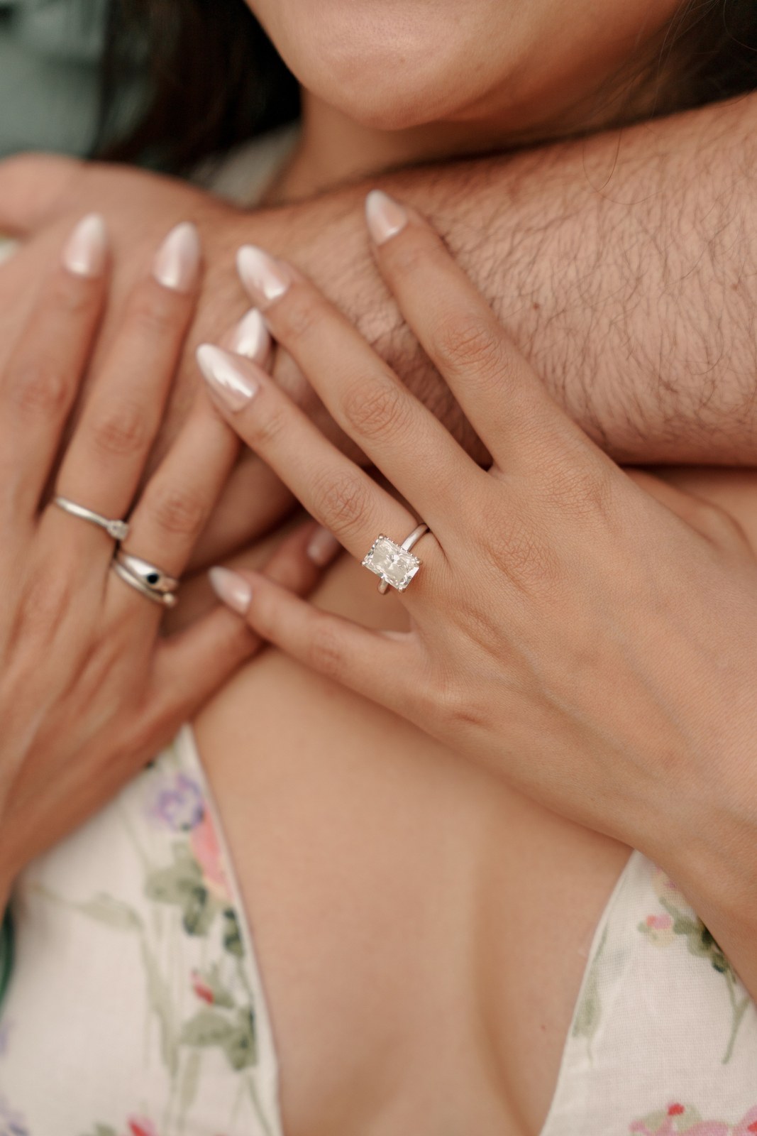 Close-up of hands showing an engagement ring