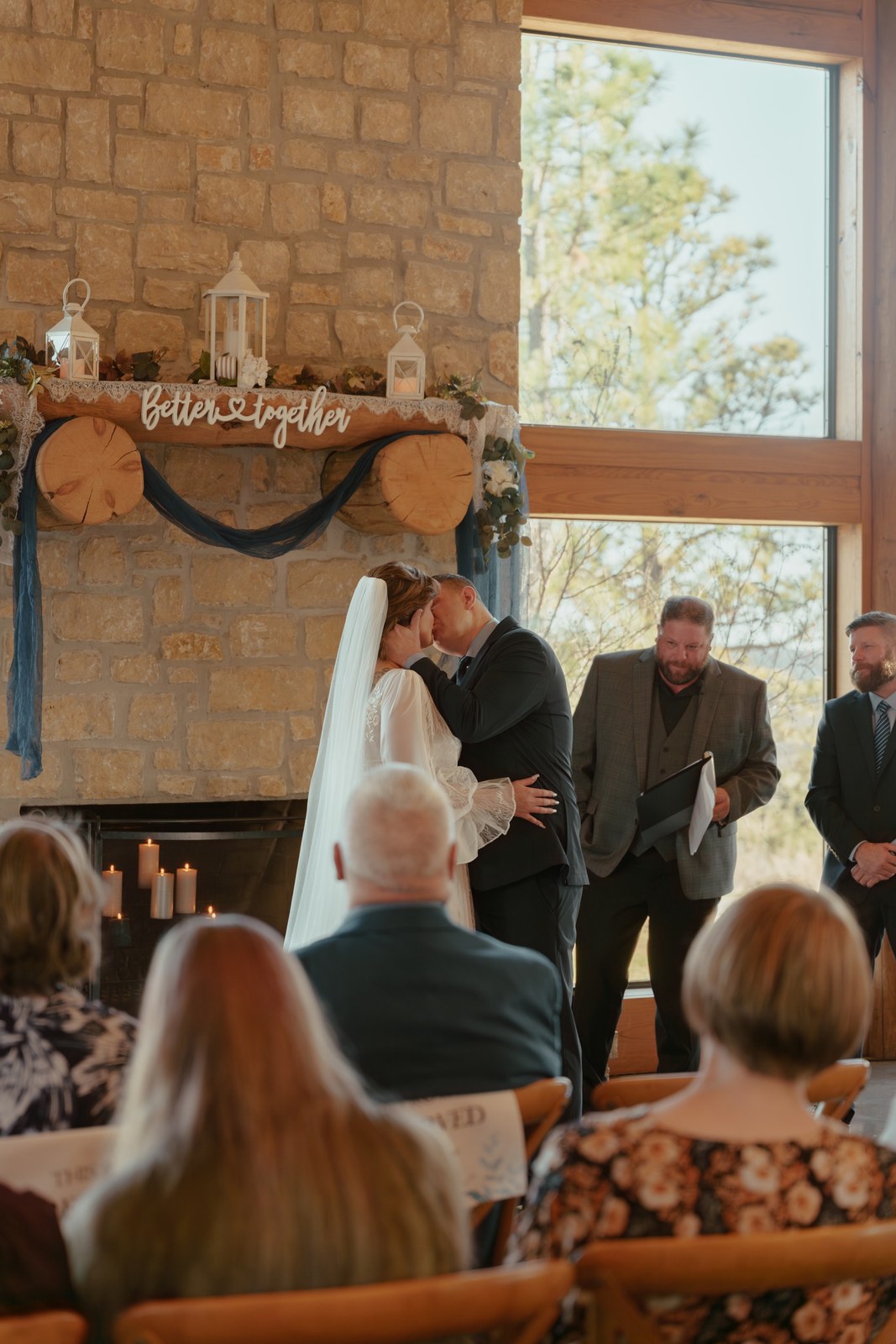 Indoor ceremony beside a stone fireplace